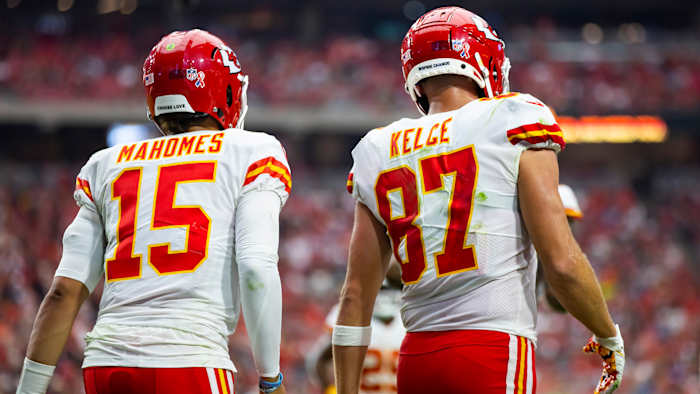 Mahomes and Kelce walk onto the field during a Chiefs game